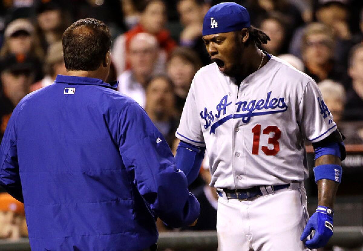 Dodgers shortstop Hanley Ramirez reacts after getting hit on the left hand by a pitch from Giants starter Ryan Vogelsong in the seventh inning Wednesday night in San Francisco.