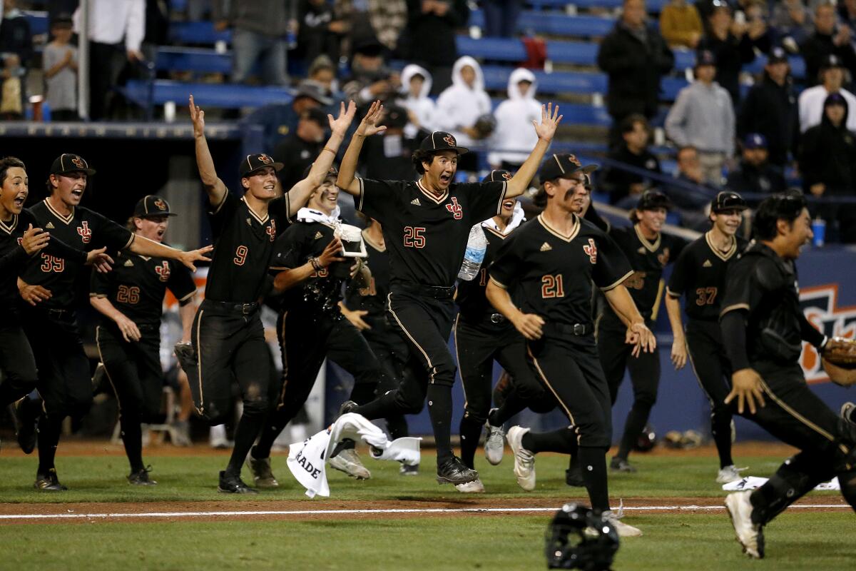 JSerra players rush the mound after relief pitcher Tyler Gough records the final out against Notre Dame on Friday.