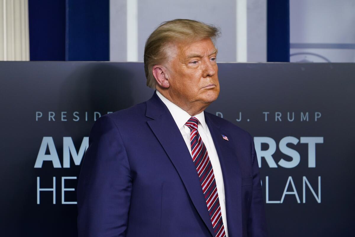 President Trump listens during a news conference