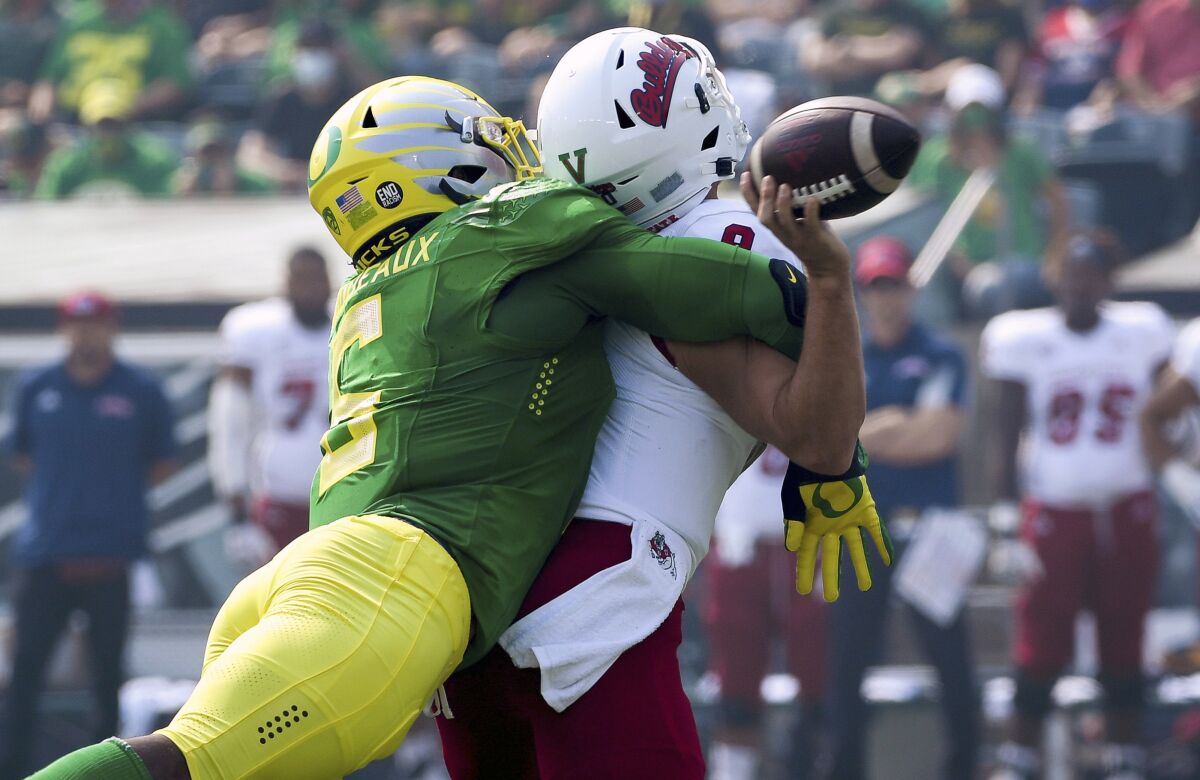 Oregon defensive end Kayvon Thibodeaux (5) hits Fresno State quarterback Jake Haener (9) causing a fumble during the first quarter of an NCAA college football game, Saturday, Sept. 4, 2021, in Eugene, Ore. (AP Photo/Andy Nelson)