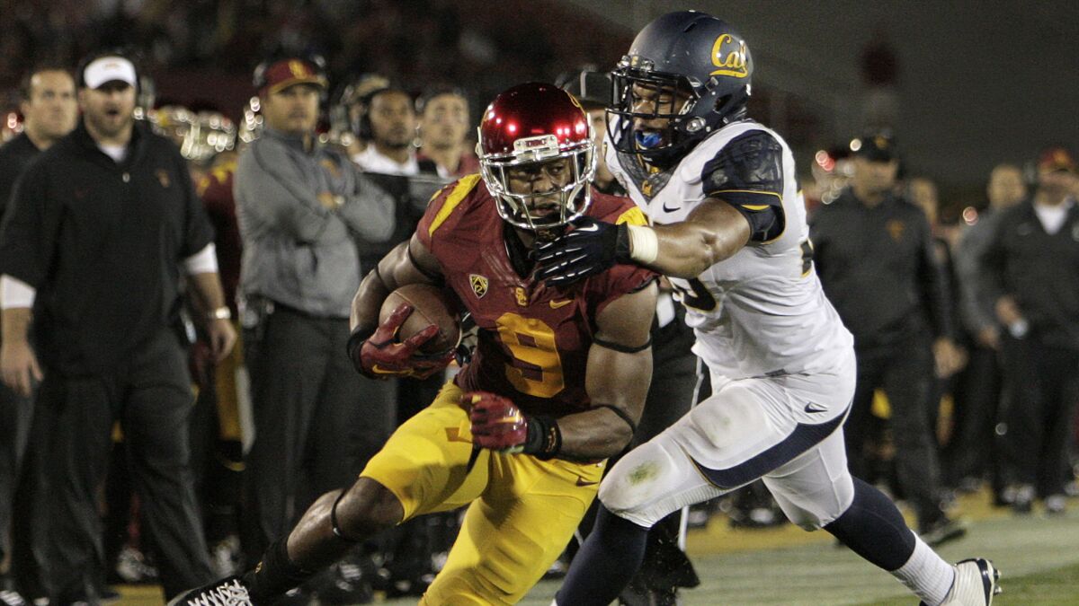 USC wide receiver JuJu Smith avoids being tackled by California defensive end Noah Westerfield on an eight-yard reception during the Trojans' win on Thursday.