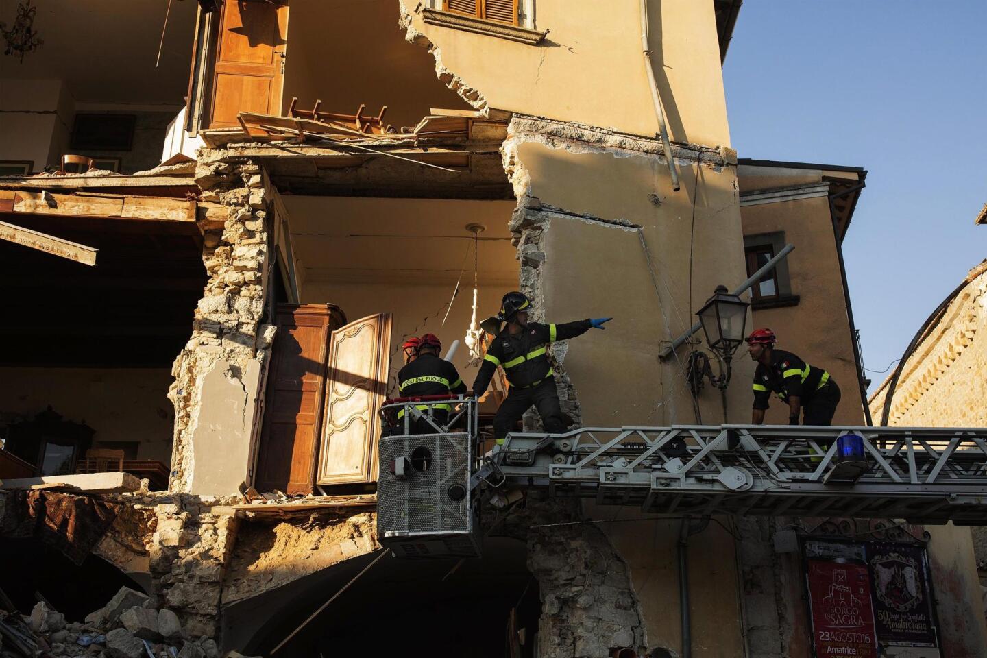 Rescue workers dig through the rubble Aug. 27, 2016, in the earthquake-stricken town of Amatrice, Italy, three days after the devastating quake.