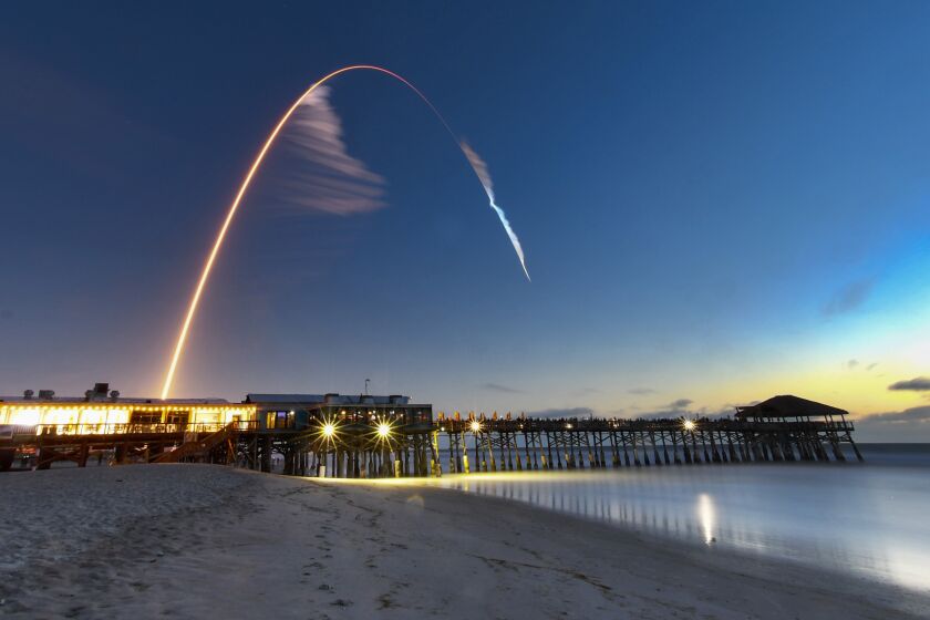 A United Launch Alliance Atlas V rocket carrying the Boeing Starliner crew capsule on an Orbital Flight Test to the International Space Station lifts off from Space Launch Complex 41 at Cape Canaveral Air Force station, Friday, Dec. 20, 2019, in this four minute time exposure of the launch with the Cocoa Beach, Fla., Pier in the foreground. (Malcolm Denemark/Florida Today via AP)