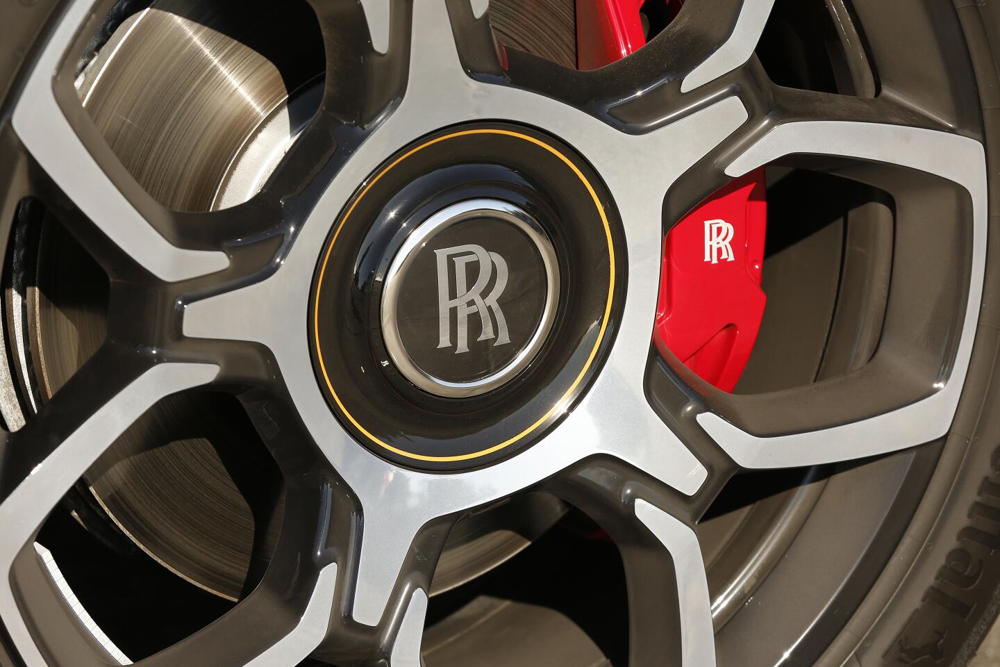 A tire with the Rolls-Royce logo in the center of the hubcap.