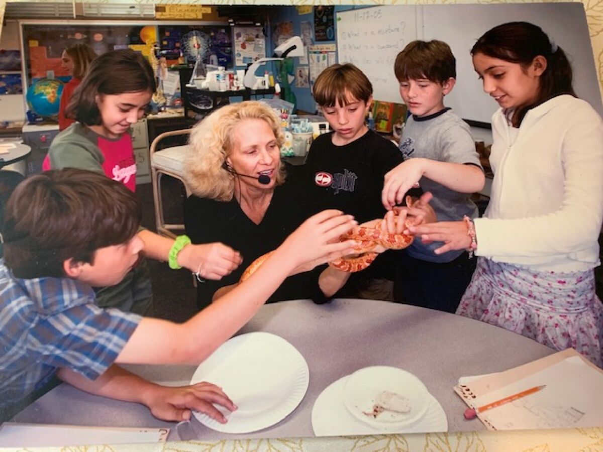 Cathy Isom, a science teacher at Torrey Pines Elementary, is pictured in 2005 with fifth-graders and the class corn snake. 