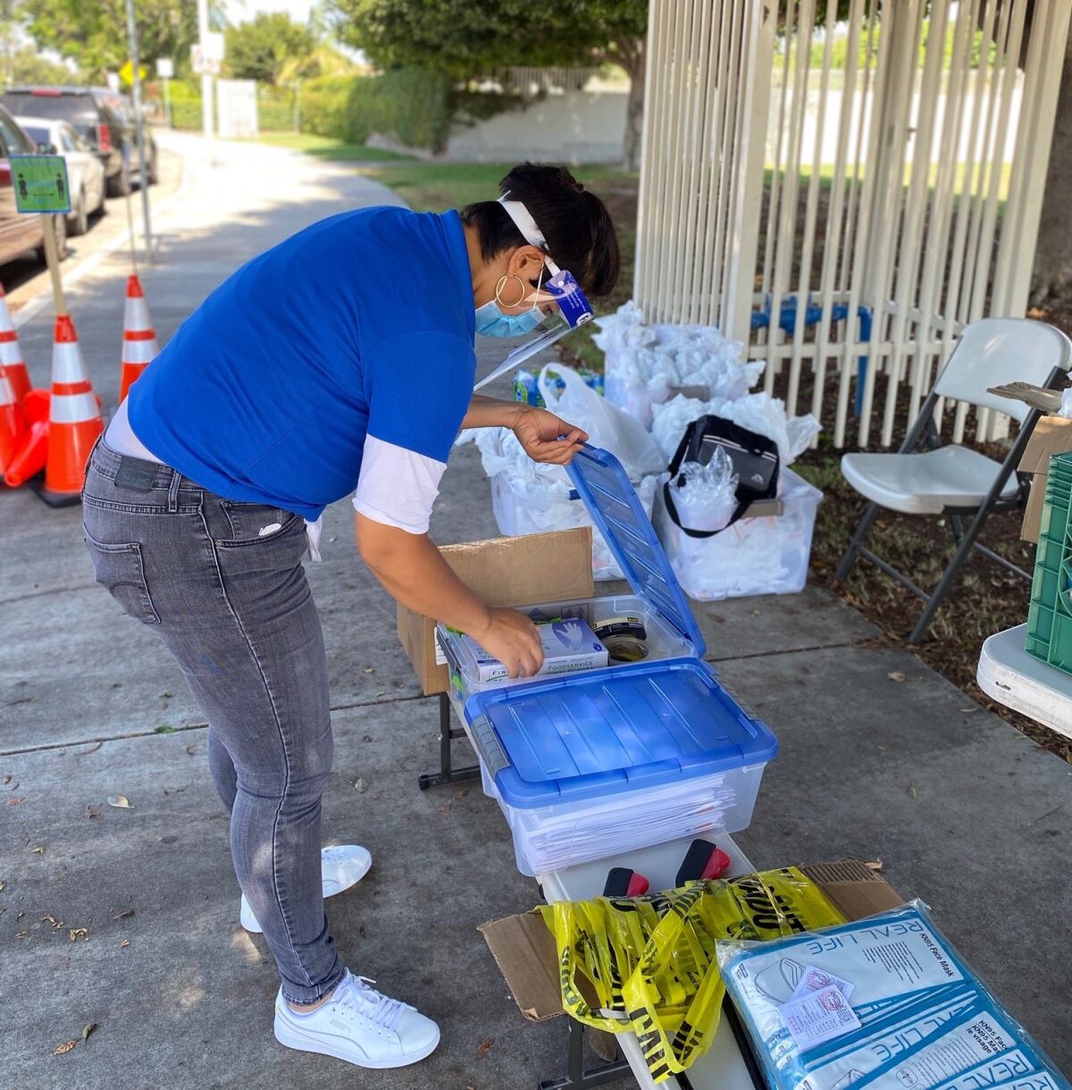 A health advocate handles coronavirus testing supplies