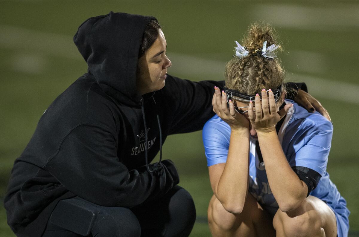 Corona del Mar's Belle Grace, right, is consoled by a teammate following a loss to Newport Harbor in a CIF semifinal.