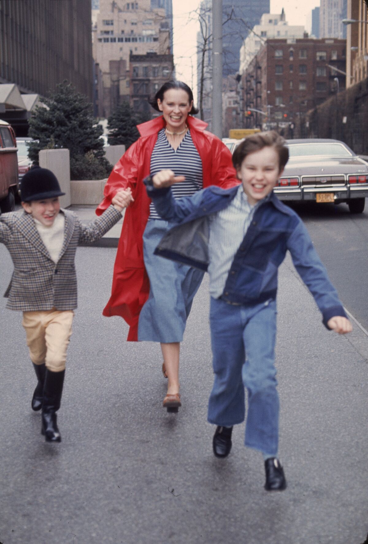 Socialite Gloria Vanderbilt runs down the street with her sons Anderson Cooper, left, and Carter Vanderbilt Cooper in New York.