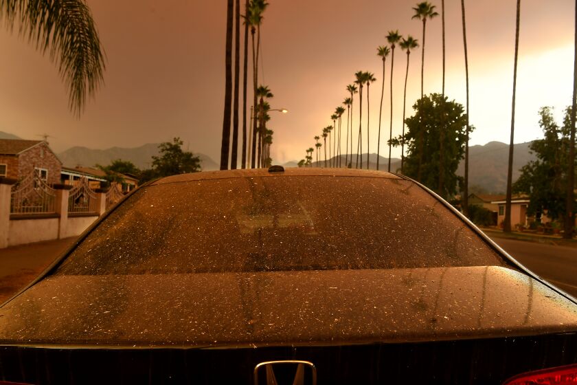AZUZA, CALIFORNIA SEPTEMBER 9, 2020-Ash falls ona parked car as the Bobcat Fire burns in the distance Wednesday morning. (Wally Skalij/Los Angeles Times)