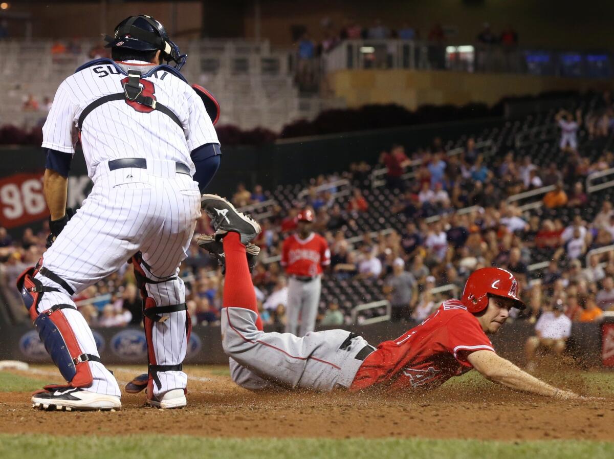 Pinch runner Tony Campana slides home to score the game-winning run on a sacrifice fly by Chris Iannetta in the ninth inning. The Angels beat the Twins, 5-4.