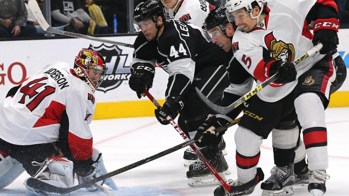 Kings forwards Vincent LeCavalier (44) and Jeff Carter, next to Senators defensman Cody Ceci (5) look for a rebound after Ottawa goalie Craig Anderson made a save Saturday night.