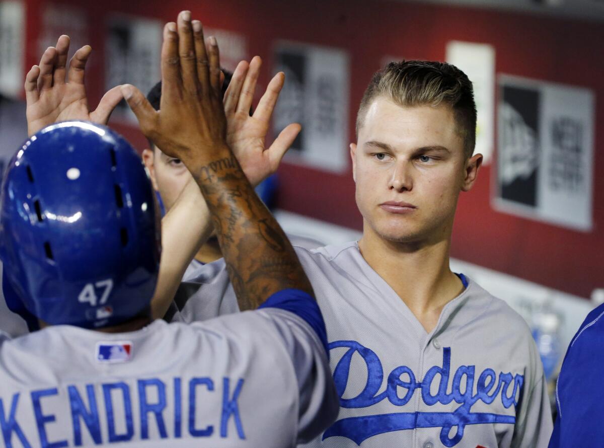 Dodgers outfielder Joc Pederson gives a high-five to teammate Howie Kendrick during a game against the Diamondbacks.