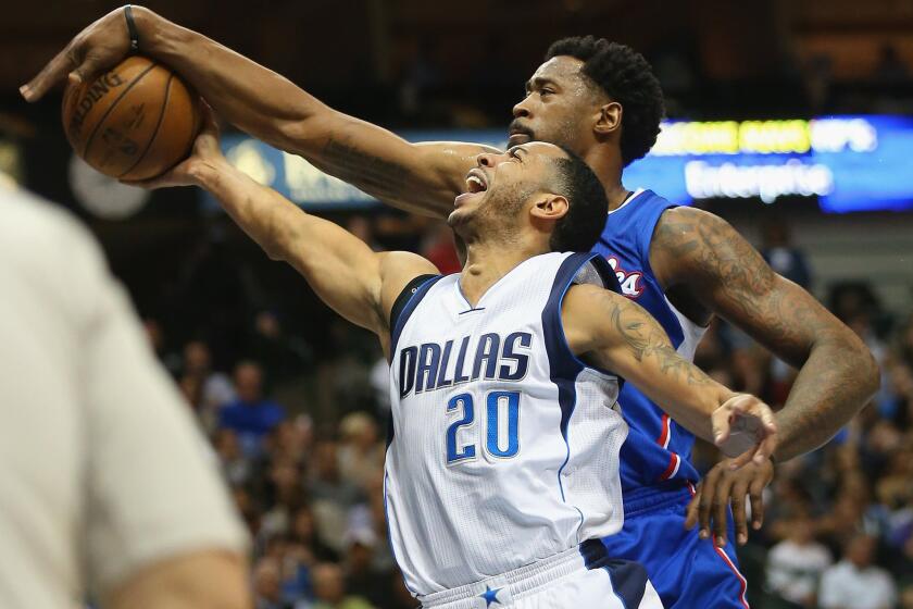Clippers center DeAndre Jordan smothers a shot attempt by Mavericks guard Devin Harris in the Clippers' 115-98 win.