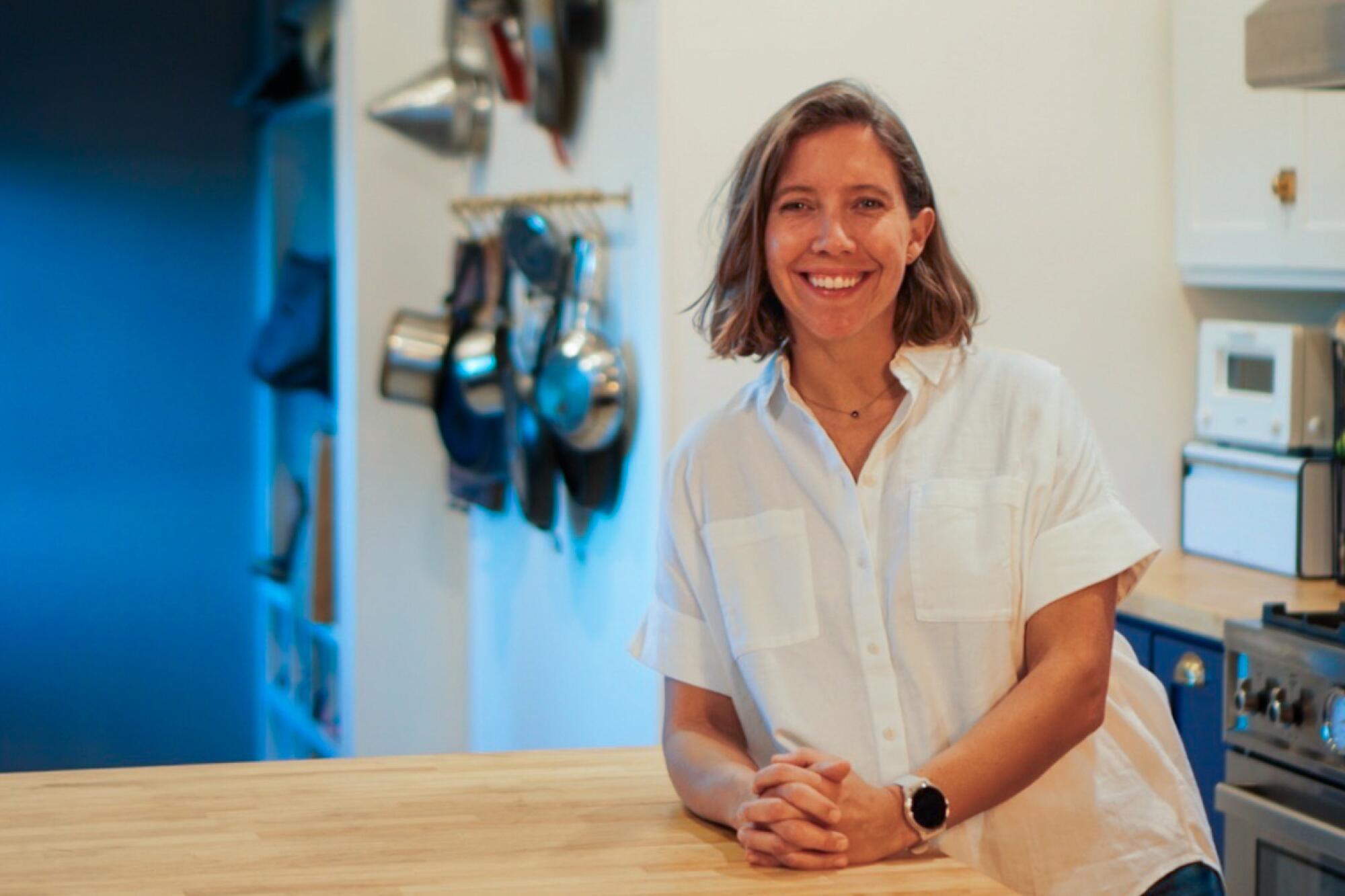Andrea Borgen Abdallah smiles in her kitchen.