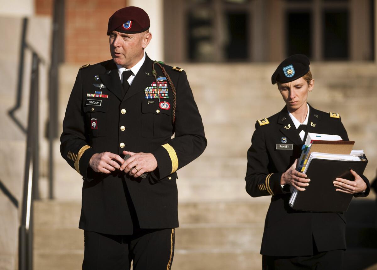 U.S. Army Brig. Gen. Jeffrey A. Sinclair, left, leaves a Ft. Bragg courthouse in January with a member of his defense team, Maj. Elizabeth Ramsey.