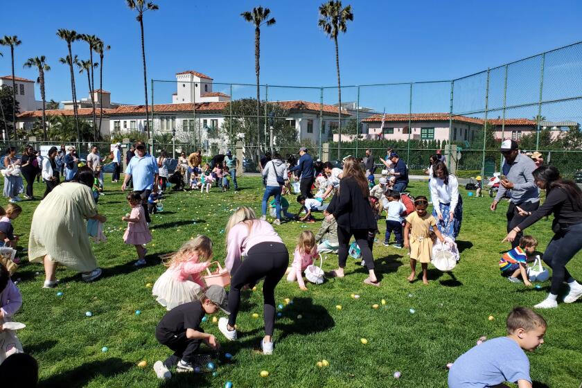 Children and their parents storm the La Jolla Recreation Center lawn during the 2023 Hippity Hop Egg-stravaganza.