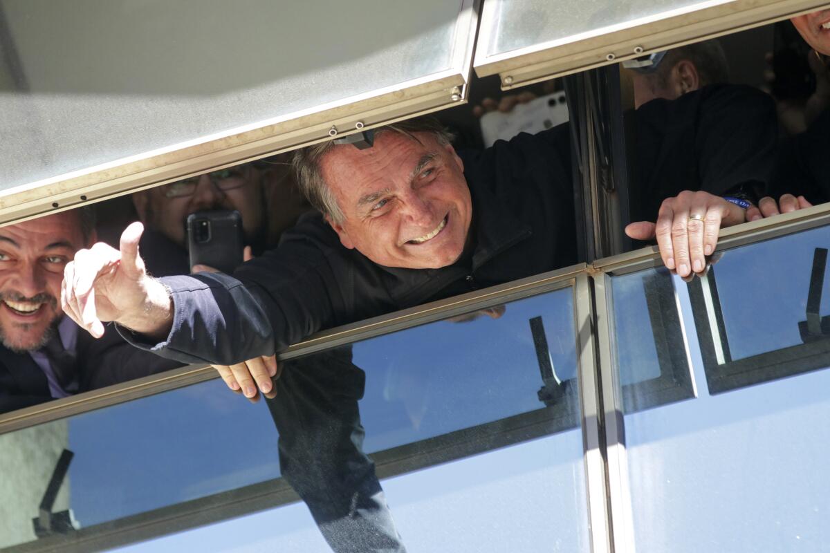Former Brazilian President Jair Bolsonaro waving to supporters