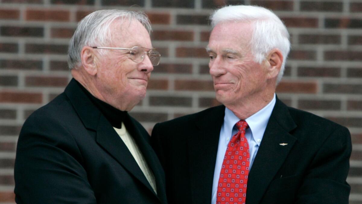 Neil Armstrong, left, is congratulated by Gene Cernan following the dedication ceremony of the Neil Armstrong Hall of Engineering at Purdue University in West Lafayette, Ind. in 2007.
