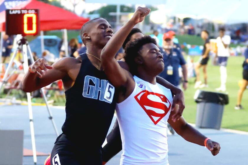 Rodrick Pleasant (right) and Dijon Stanley share a moment of friendship after the 200 meters at the state championships.