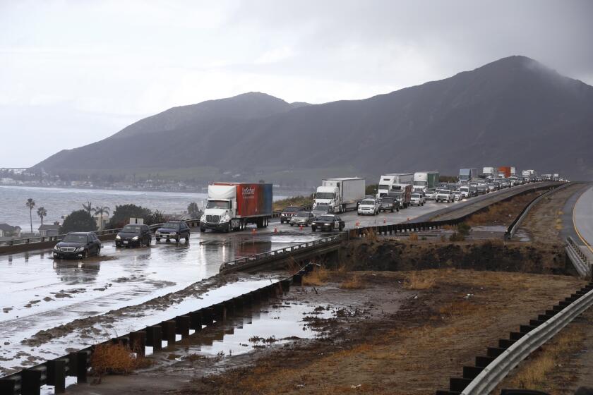 Southbound traffic on the 101 Freeway in Ventura County crawls through one lane Tuesday after mud flowed over the freeway.