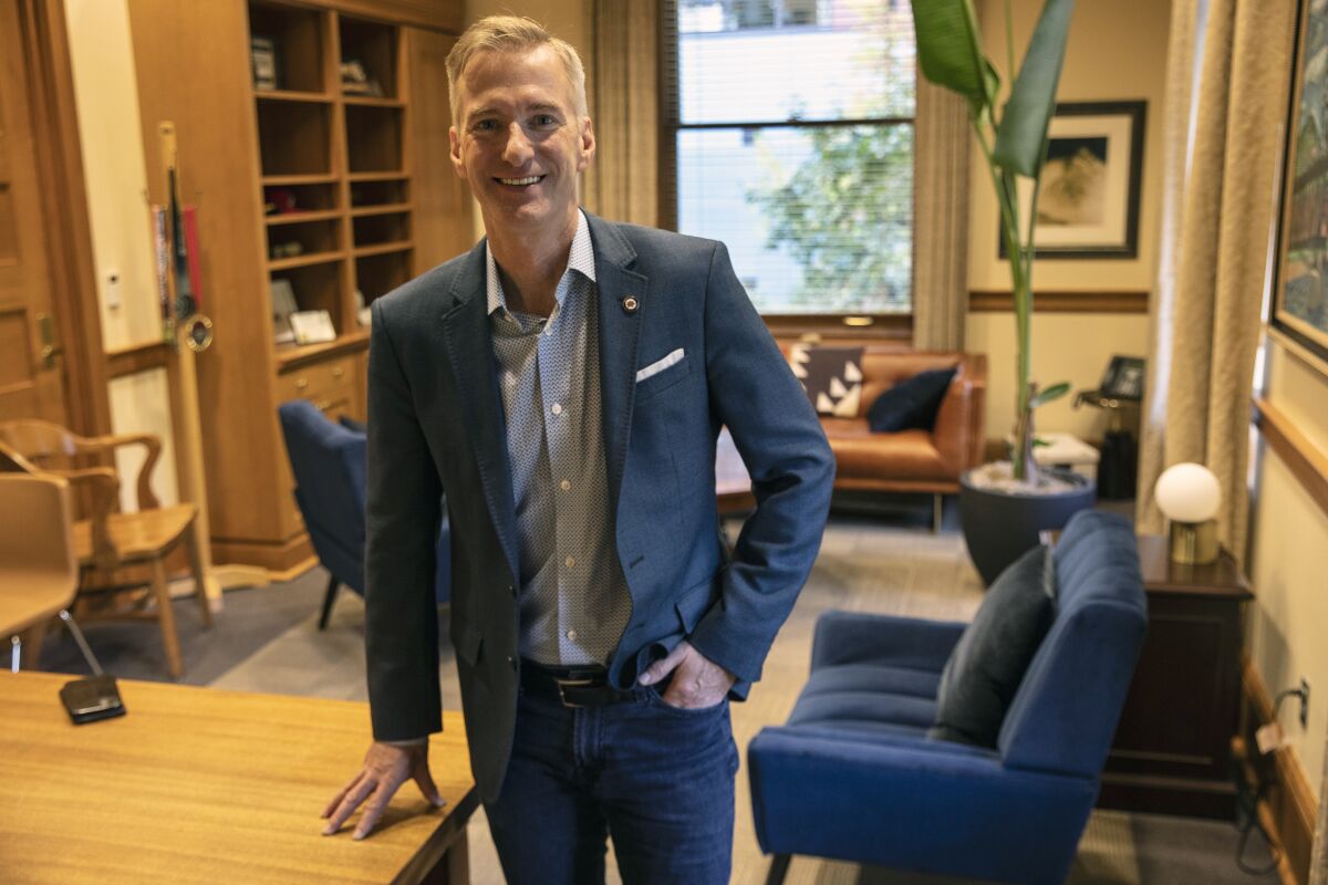 FILE - In this Oct. 9, 2020, file photo, Mayor Ted Wheeler poses in a City Hall office in Portland, Ore. Mayor Wheeler is facing Sarah Iannarone in the election on Tuesday, Nov. 3, 2020. (AP Photo/Paula Bronstein, File)