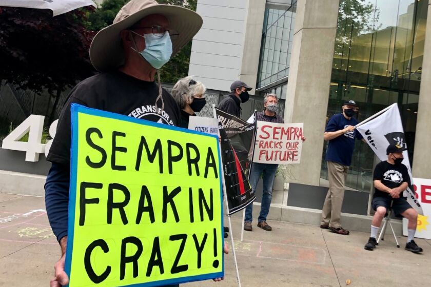 One of about 100 protesters in front of the Sempra Energy building in downtown San Diego on Friday, May 14.