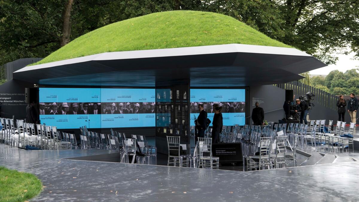 Visitors look at information displays at the newly unveiled memorial in Munich, Germany, to the 11 Israeli athletes killed in a terrorist attack during the 1972 Olympic Games there.