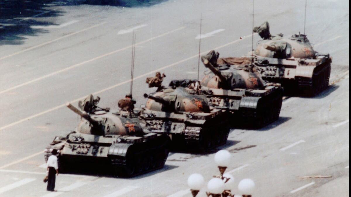 An anti–government protester stands in front of tanks in Beijing's Tiananmen Square on June 5, 1989.