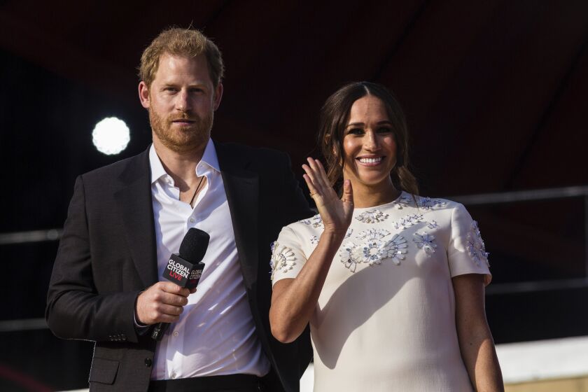 FILE - Prince Harry and his wife Meghan speak during the Global Citizen festival, on Sept. 25, 2021 in New York. Prince Harry and his wife Meghan have visited Queen Elizabeth II at Windsor Castle on their first joint visit to the U.K. since they gave up formal royal roles and moved to the U.S. more than two years ago. The couple’s office says they visited the 95-year-old queen, Harry’s grandmother, Thursday, April 14, 2022 on their way to the Netherlands to attend the Invictus Games (AP Photo/Stefan Jeremiah, File)