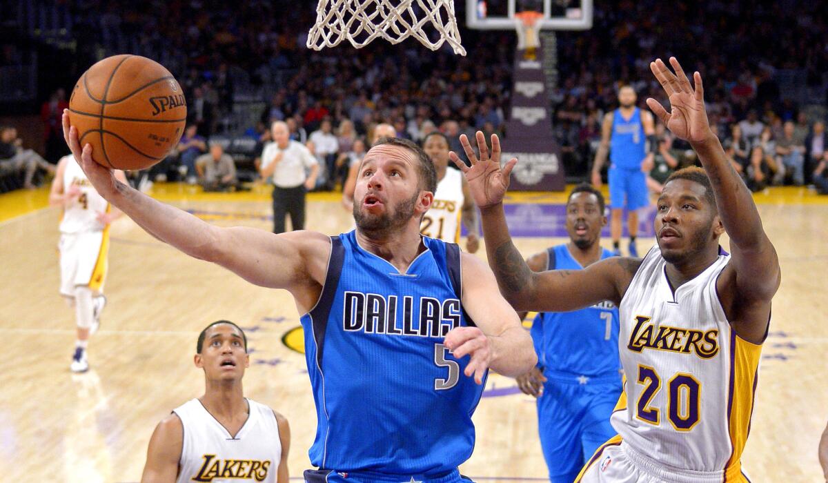 Mavericks guard J.J. Barea goes up for a shot against Lakers guard Dwight Buycks in the first half Sunday evening at Staples Center.