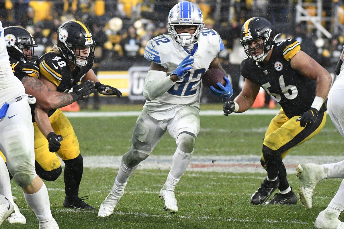 Detroit Lions running back D'Andre Swift (32) carries the ball during overtime of an NFL football game in Pittsburgh, Sunday, Nov. 14, 2021. (AP Photo/Don Wright)