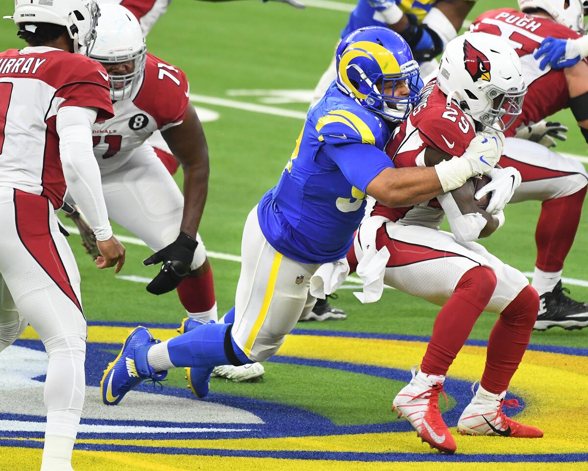 Rams defensive lineman Aaron Donald tackles Cardinals running back Chase Edmonds.