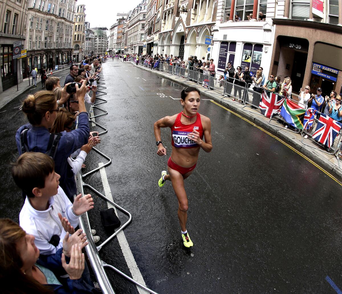 Kara Goucher running through the streets of London.