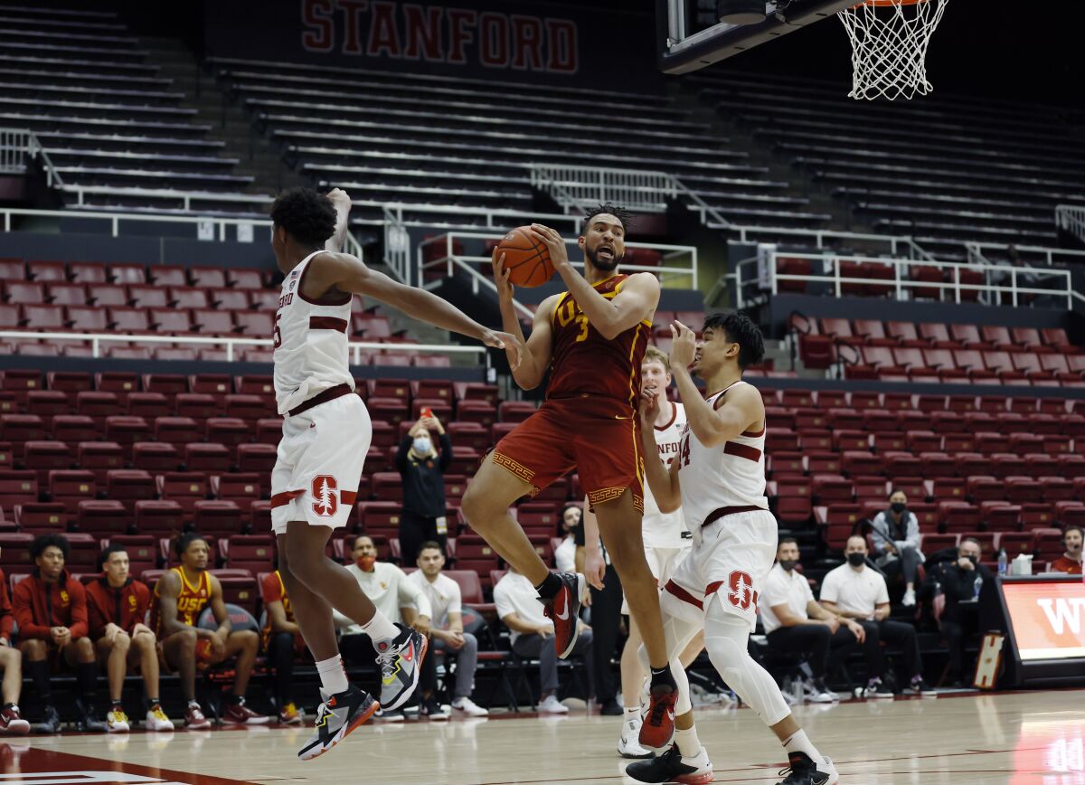 USC forward Isaiah Mobley aims for the basket against Stanford forwards Harrison Ingram and Spencer Jones.