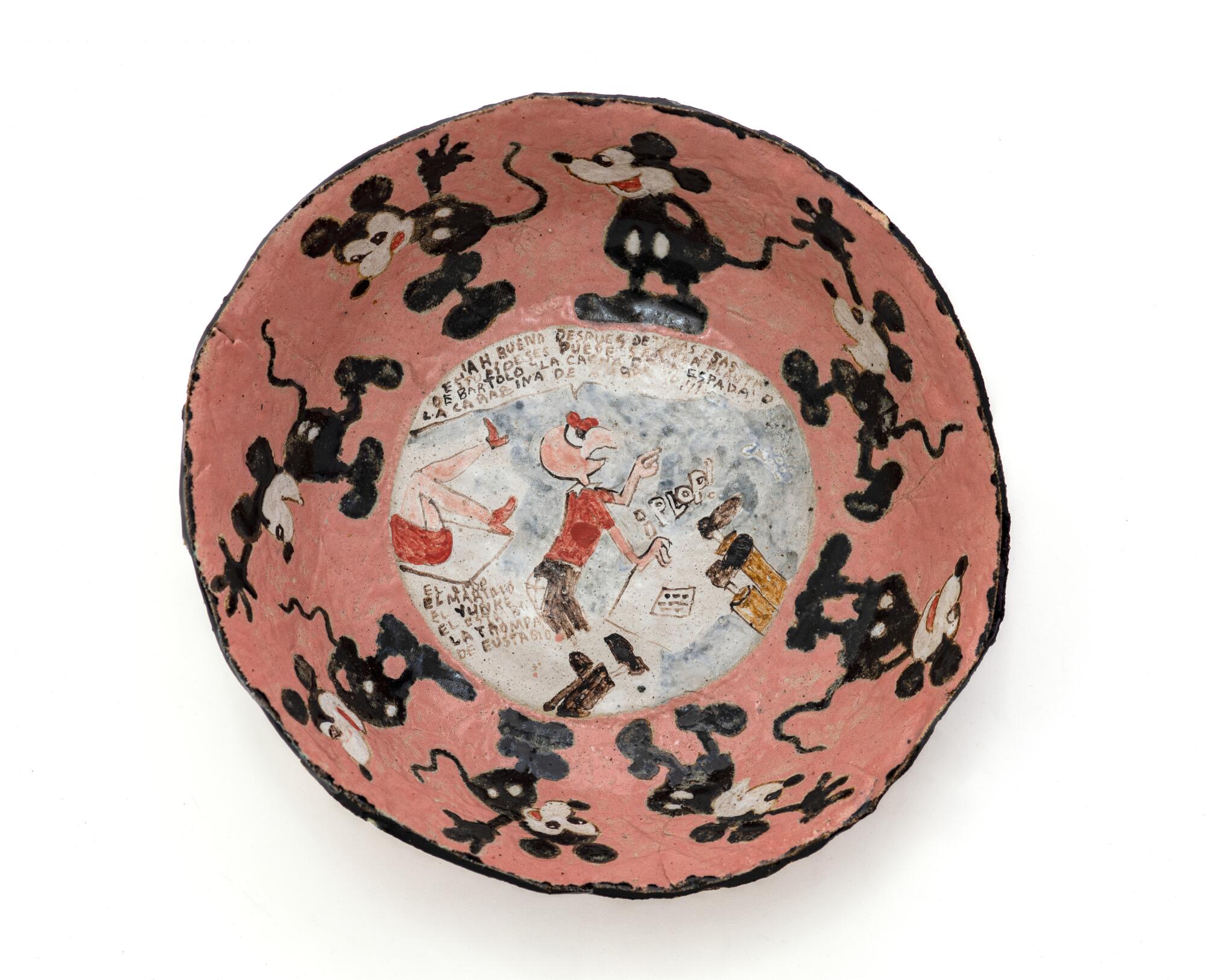 An aerial view of a salmon-colored bowl with Mickey Mouse figures circling a cartoon condor called Condorito.