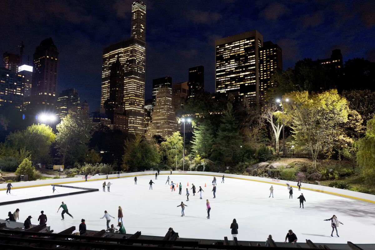 This Thursday, Nov. 3, 2016, file photo shows skaters on the the ice at Wollman Rink in New York's Central Park. New York City officials say a consortium of businesses and nonprofits has been chosen to run the rink, after canceling contracts with the company of former president Donald Trump. The city Parks Department said Tuesday, July 6, 2021, that a joint venture called Wollman Park Partners LLC is expected to be awarded a five-year contract to run the rink. (AP Photo/Mark Lennihan, File)