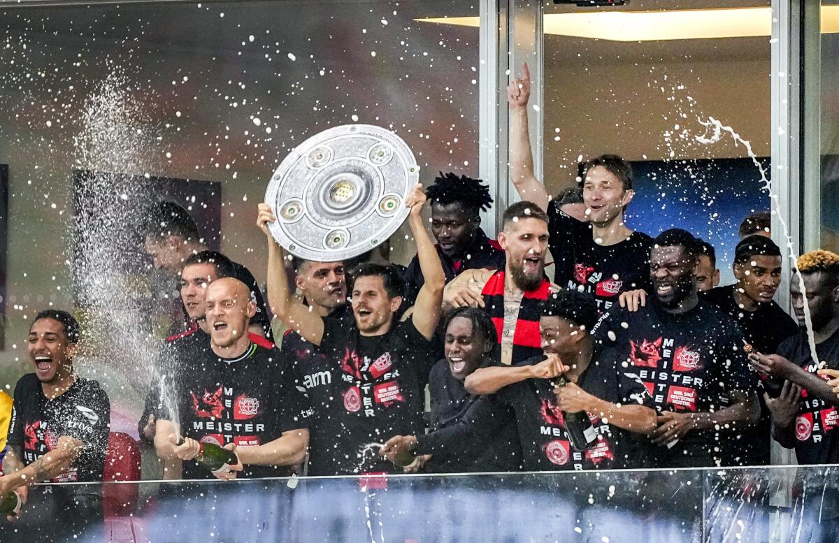 Bayern Leverkusen players celebrate after winning the Bundesliga title on Sunday.
