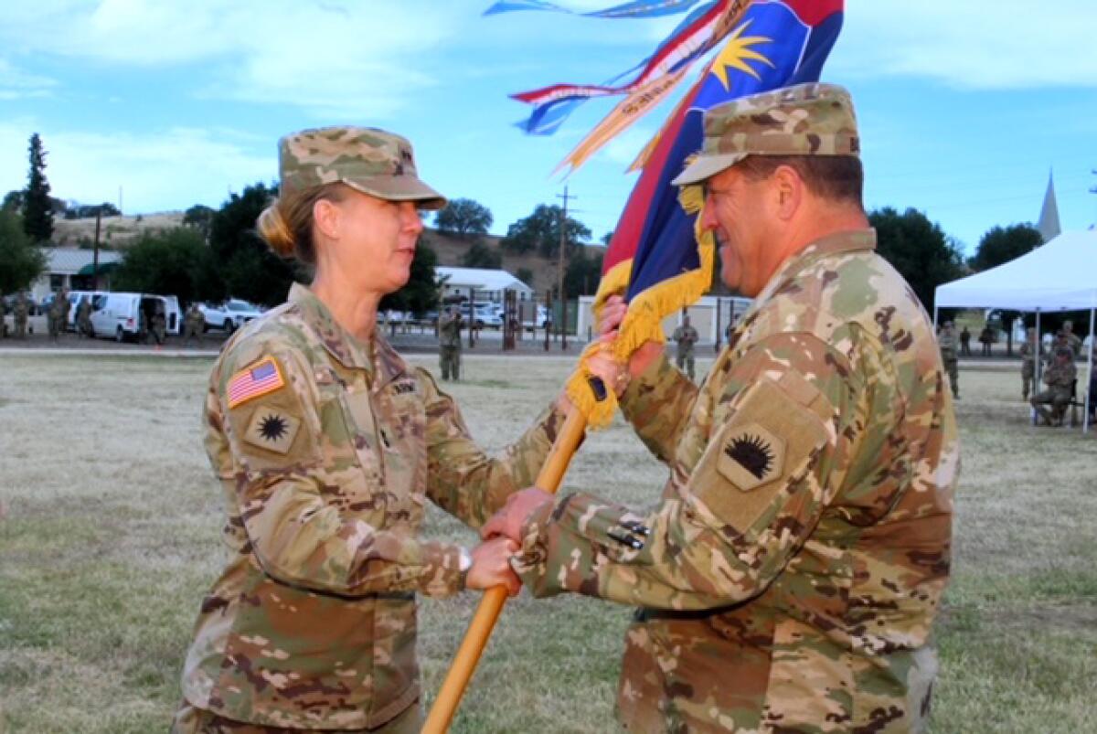 Maj. Gen. Laura Yeager hands off the 40th Infantry Division's battle colors to Maj. Gen. David S. Baldwin on May 15.