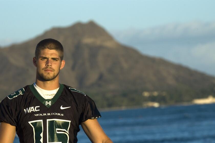 HONOLULU - AUGUST 16: Quarterback Colt Brennan or the University of Hawaii Warriors poses for a photo on Waikiki Beach with Diamond Head mountain in background on August 16, 2007 in Honolulu, Hawaii. (Photo by Lucy Pemoni/Getty Images)