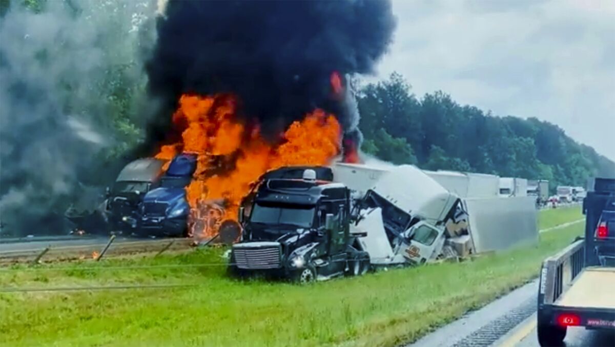 In this image taken from video flames and smoke billow from trucks involved in a deadly multiple vehicle crash along Interstate 30 in southwestern Arkansas, Wednesday, June 8, 2022. (AP Photo/Joni Deardorff)