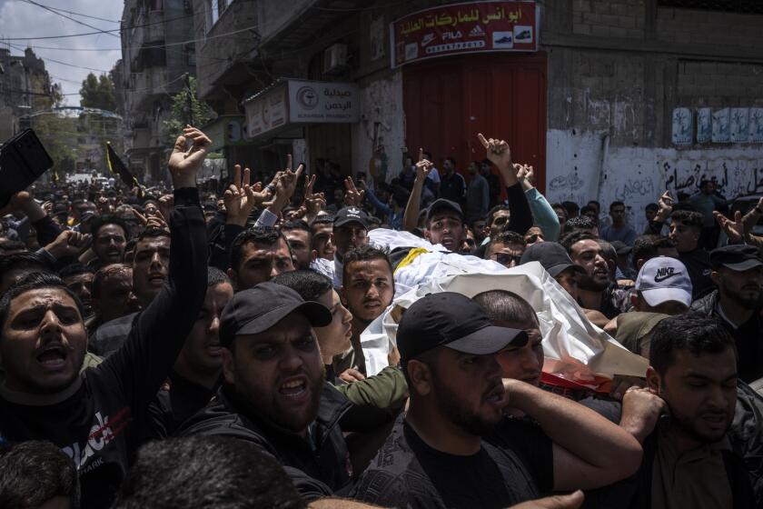 Mourners carry the bodies of Palestinians who were killed in Israeli airstrikes, during their funeral in Gaza City, Tuesday, May 9, 2023. The airstrikes killed three senior commanders of the militant Islamic Jihad group and 10 other people, including two of the commanders' wives, several of their children and others nearby. (AP Photo/Fatima Shbair)