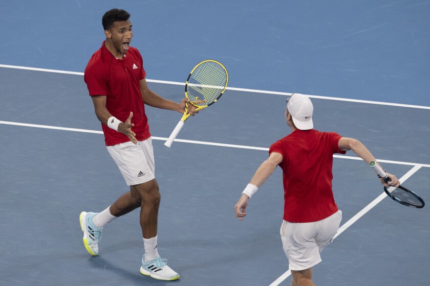 Felix Auger-Aliassime, left, and Denis Shapovalov of Canada react to winning their match against Russia's Daniil Medvedev and Roman Safiullin during their semifinal match at the ATP Cup tennis tournament in Sydney, Saturday, Jan. 8, 2022. (AP Photo/Steve Christo)