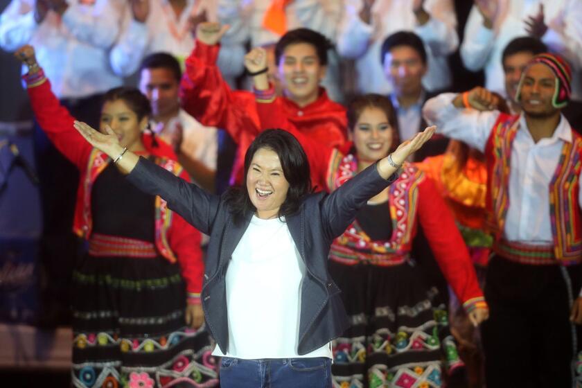 Peruvian presidential candidate Keiko Fujimori greets her supporters during a campaign event in Lima. Peruvians will go to the polls Sunday to decide a runoff between Fujimori and Pedro Pablo Kuczynski.