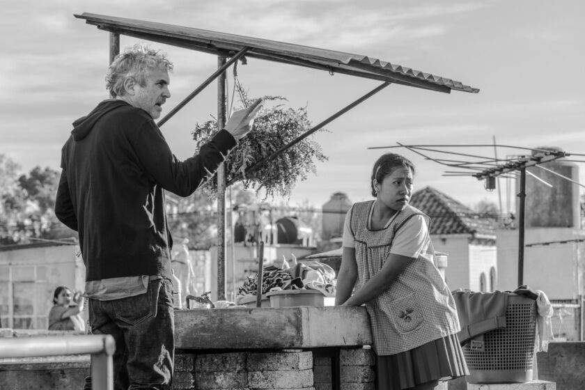 This image released by Netflix shows filmmaker Alfonso Cuaron, left, and Yalitza Aparicio on the set of "Roma." On Tuesday, Jan. 22, 2019, Cuaron was nominated for an Oscar for best director for his work on the film. The 91st Academy Awards will be held on Feb. 24. (Carlos Somonte/Netflix via AP)