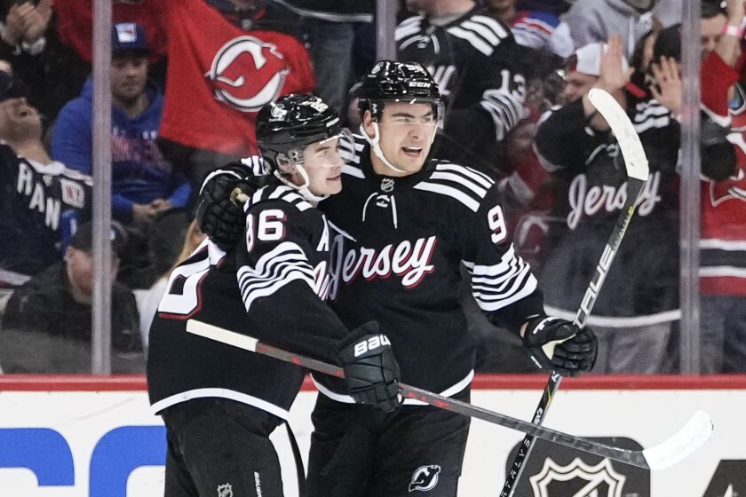 New Jersey Devils' Timo Meier, right, celebrates with teammate Jack Hughes after scoring a goal during the first period of an NHL hockey game against the New York Rangers Thursday, March 30, 2023, in Newark, N.J. (AP Photo/Frank Franklin II)