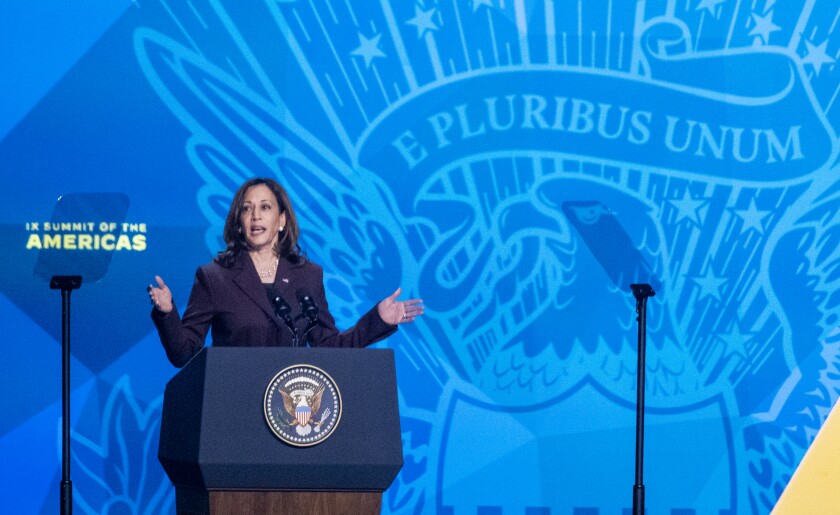 Vice President Kamala Harris speaks at a lectern during the Summit of the Americas.