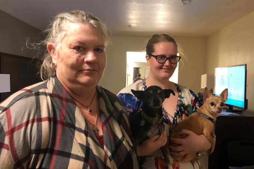 Michele Newton, left, and her daughter Brenna Delwisch have evacuated to a hotel at their own expense because Newton requires electricity to run a breathing machine at night.