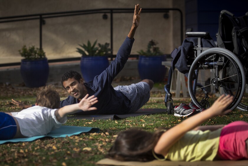 Obi Ndefo has resumed teaching the yoga classes he taught kids before the crash at Bridges Academy in Studio City.