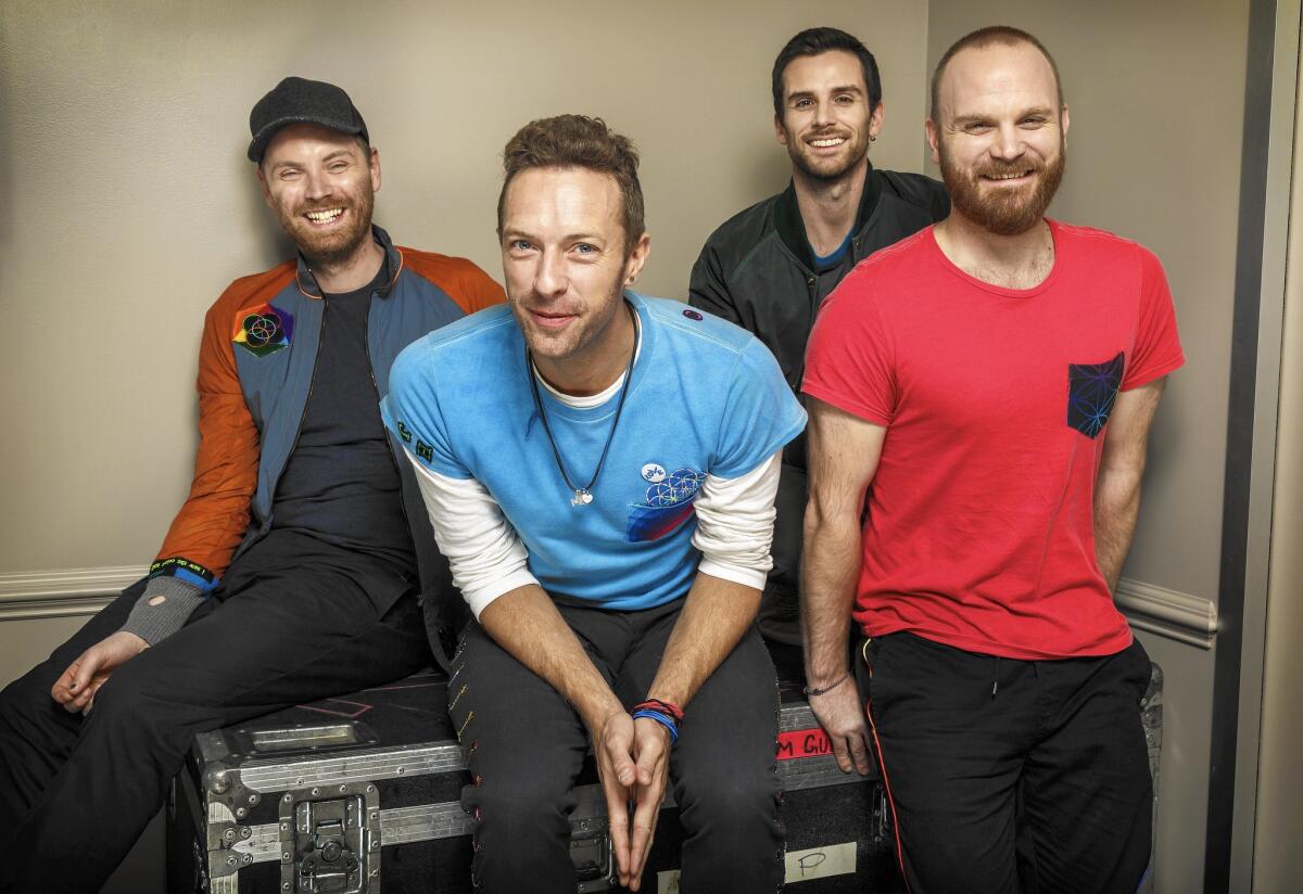 Coldplay: Jonny Buckland, left, Chris Martin, Guy Berryman and Will Champion at CBS studios before a taping of the "The Late Show with James Corden" on Nov. 12, 2015.