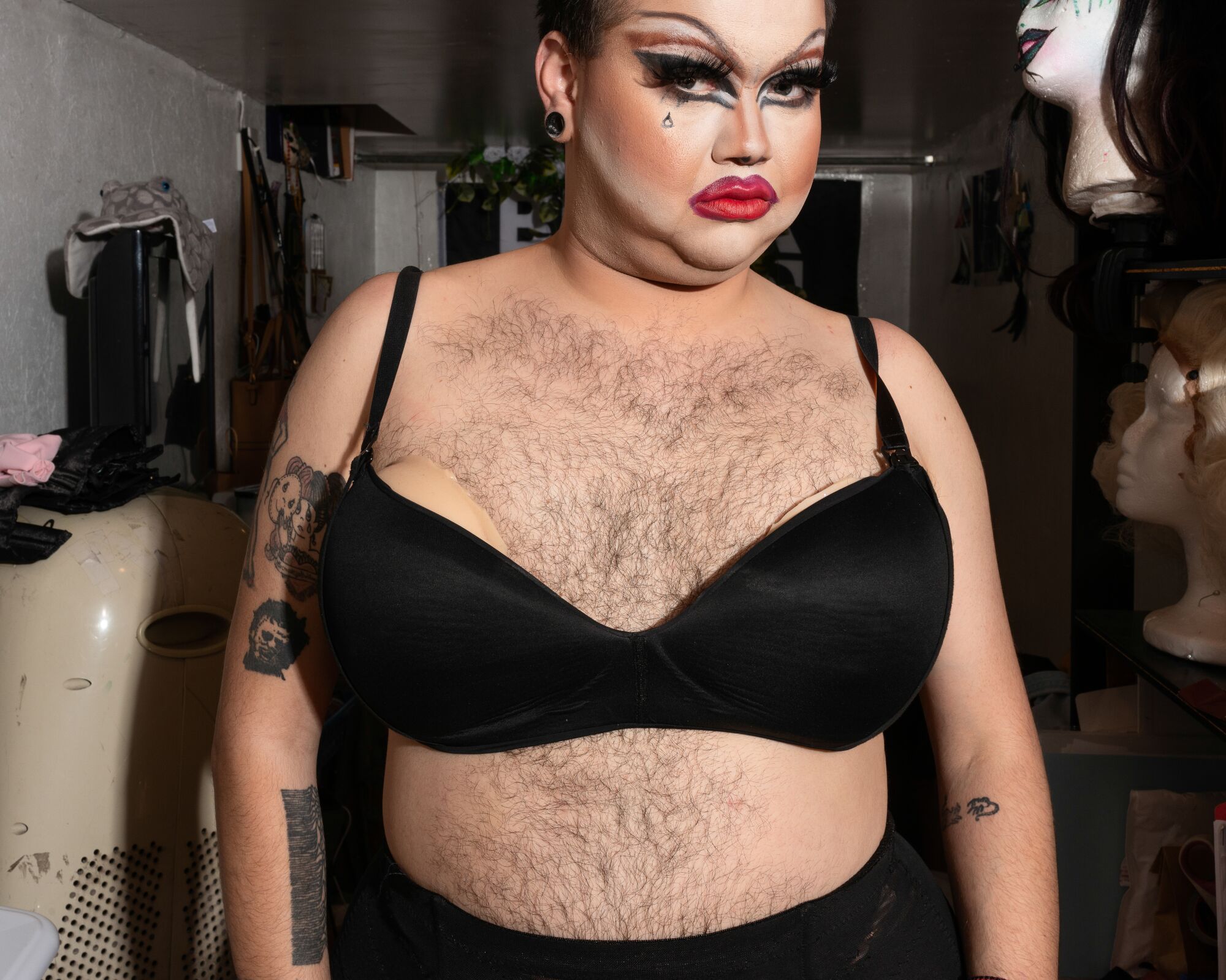Phillip Hurt shows off his chest hair and black bra.